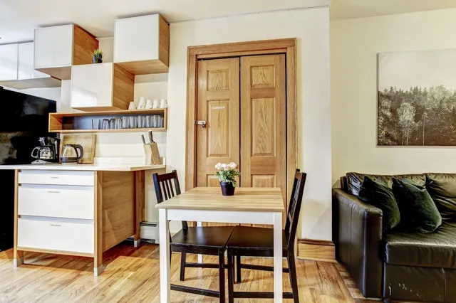 a dining room with furniture and a window