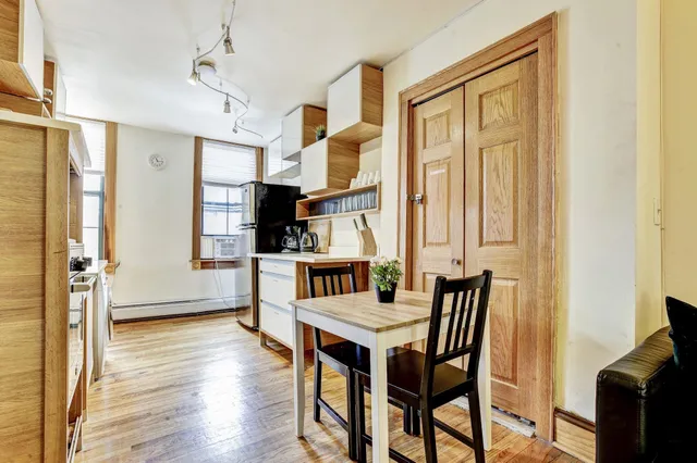 a view of a dining room with furniture and a window