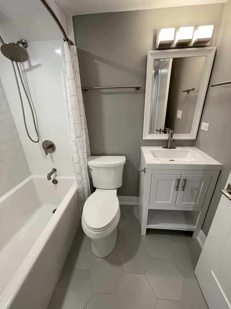 Undisclosed Address Chicago, IL 60622 - Photo 7 of 13 a bathroom with a toilet sink and mirror