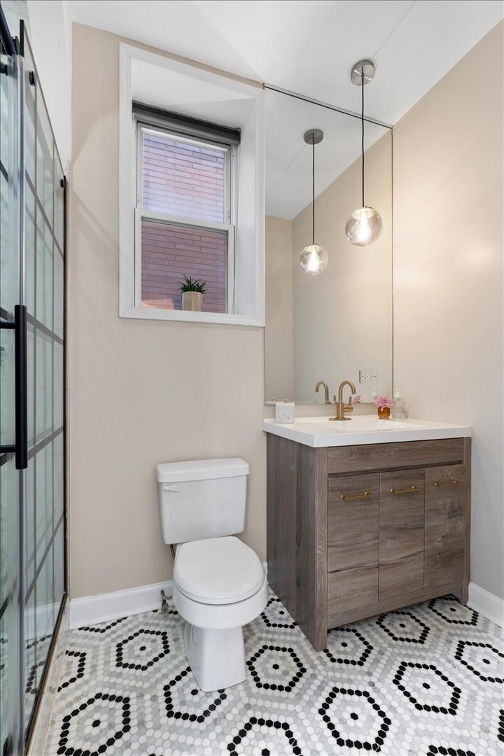 514 North Armour Street, Unit 1F Chicago, IL 60642 - Photo 12 of 18 a bathroom with a toilet sink and mirror