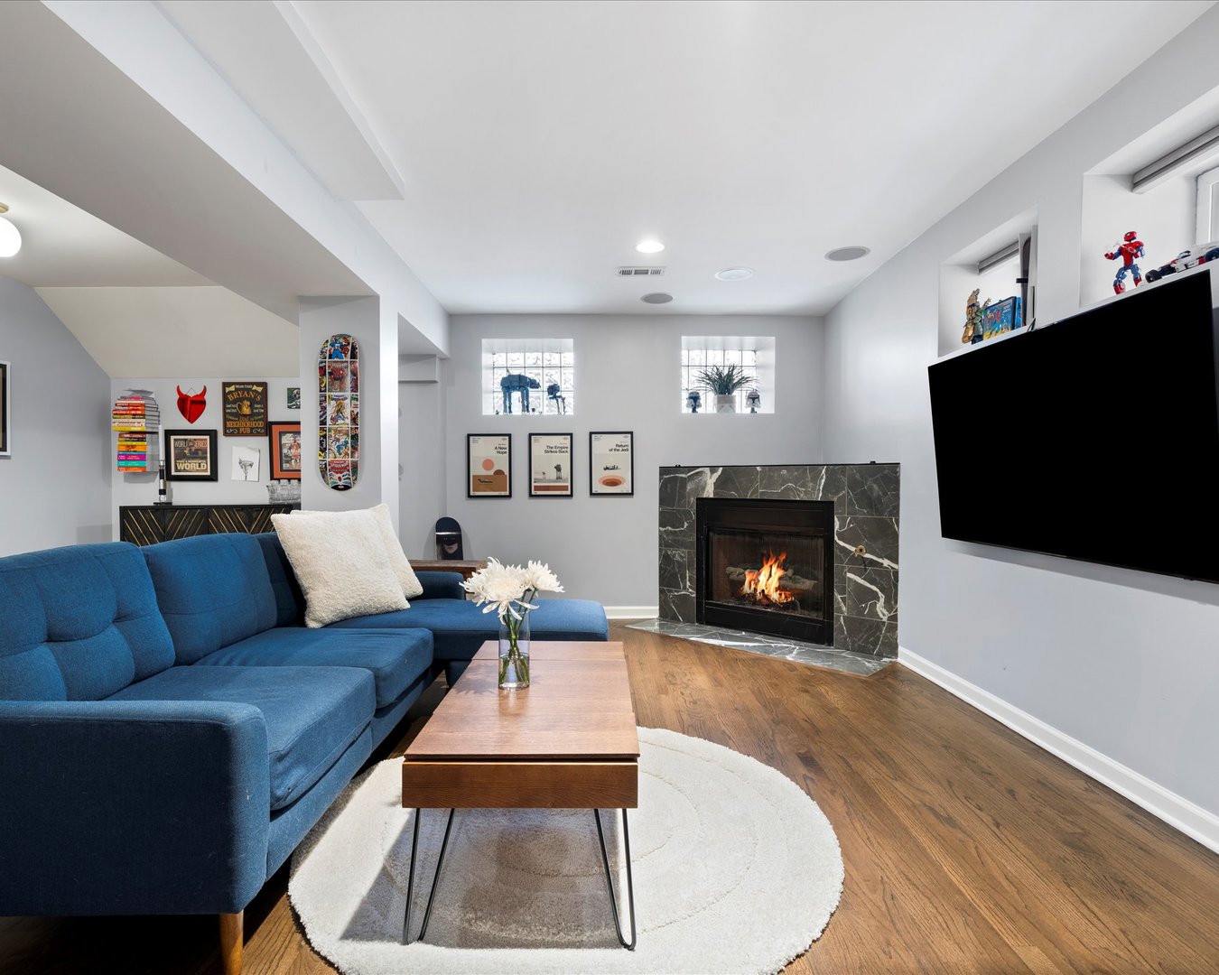 514 North Armour Street, Unit 1F Chicago, IL 60642 - Photo 14 of 18 a living room with furniture a flat screen tv and a fireplace