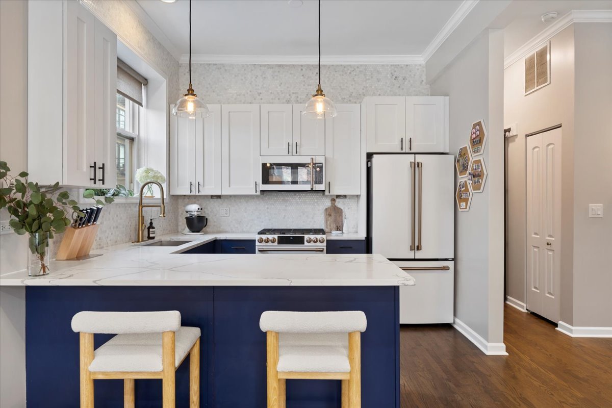 514 North Armour Street, Unit 1F Chicago, IL 60642 - Photo 6 of 18 a kitchen with stainless steel appliances a sink a refrigerator and wooden cabinets