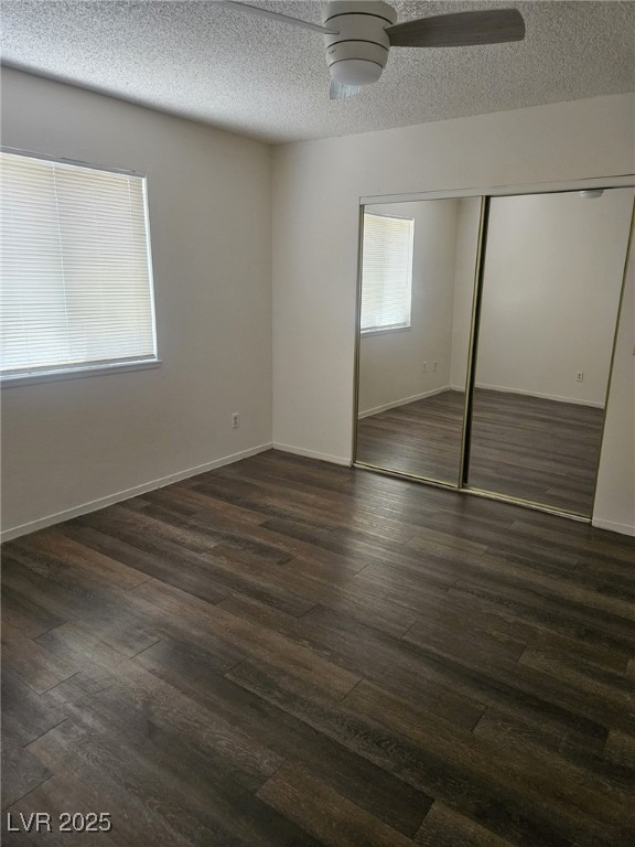 5576 West Rochelle Avenue, Unit 31A Las Vegas, NV 89103 - Photo 6 of 11 Unfurnished bedroom featuring a closet, a textured ceiling, dark wood-type flooring, ceiling fan, and baseboards