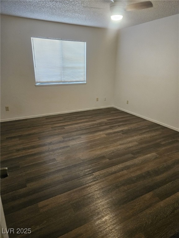 5576 West Rochelle Avenue, Unit 31A Las Vegas, NV 89103 - Photo 8 of 11 Spare room with dark wood-type flooring, a textured ceiling, baseboards, and a ceiling fan