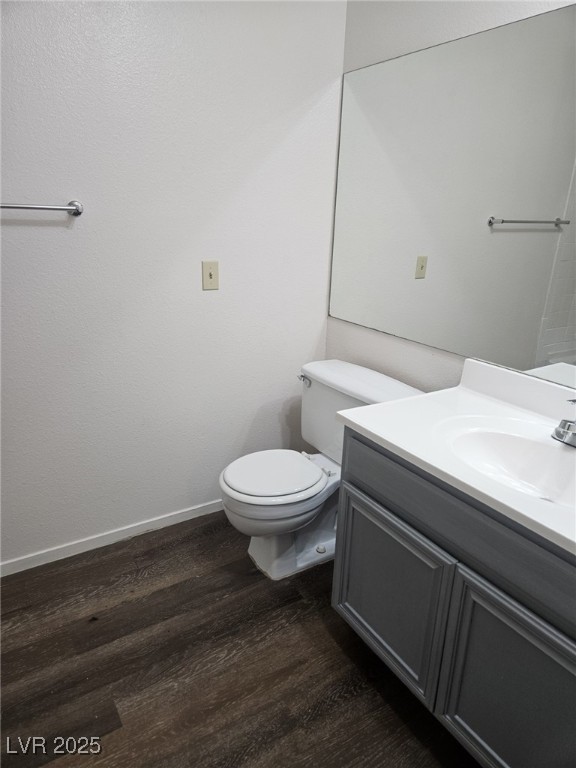 5576 West Rochelle Avenue, Unit 31A Las Vegas, NV 89103 - Photo 10 of 11 Bathroom featuring wood finished floors, toilet, vanity, and baseboards
