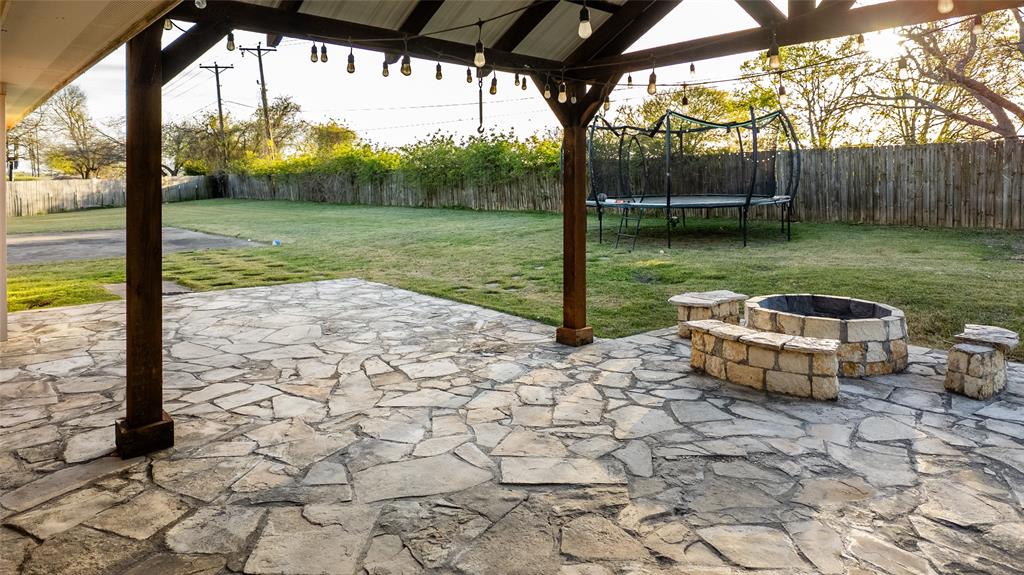 124 Topaz Circle Hewitt, TX 76643 - Photo 27 of 29 Fenced backyard with an outdoor fire pit, a patio area, and a trampoline