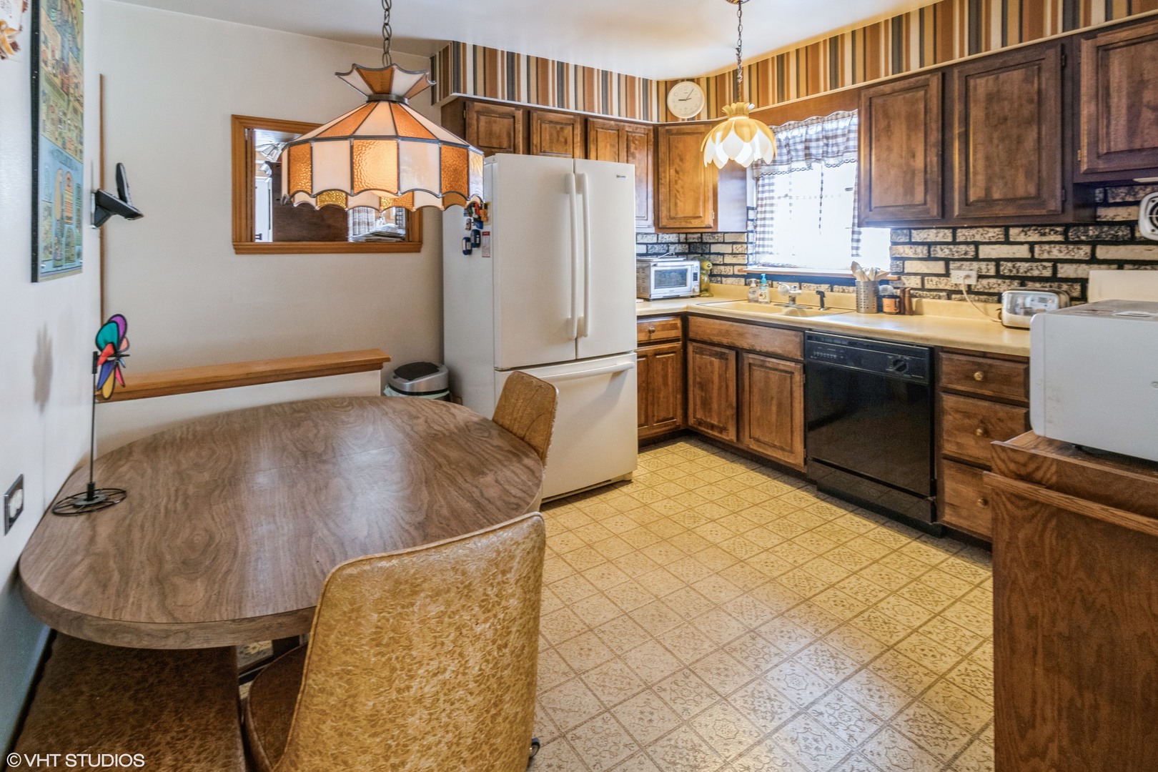 233 High Ridge Road Hillside, IL 60162 - Photo 3 of 10 a kitchen with stainless steel appliances granite countertop a sink a stove a refrigerator a washer and dryer
