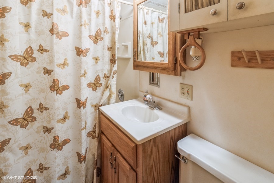 233 High Ridge Road Hillside, IL 60162 - Photo 8 of 10 a bathroom with a sink and a mirror