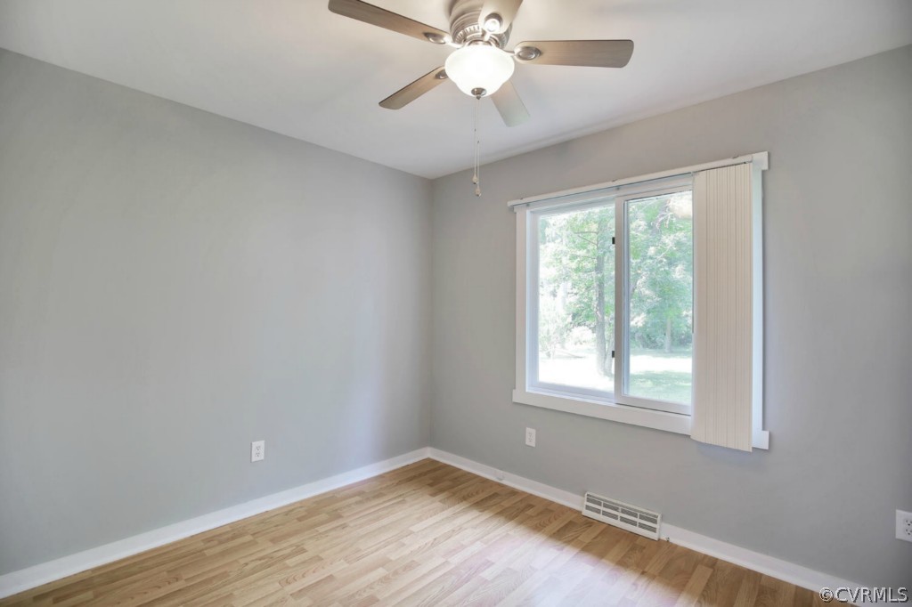 14060 Beach Road Chesterfield, VA 23838 - Photo 12 of 24 a view of an empty room with wooden floor and a window