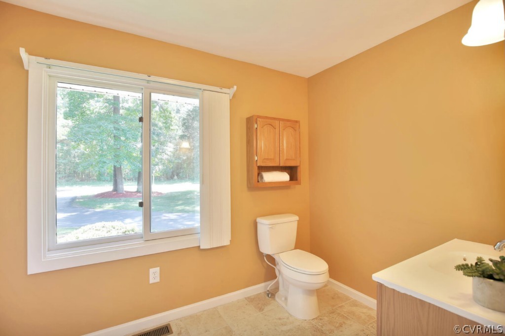 14060 Beach Road Chesterfield, VA 23838 - Photo 17 of 24 a white toilet sitting next to a bathroom sink