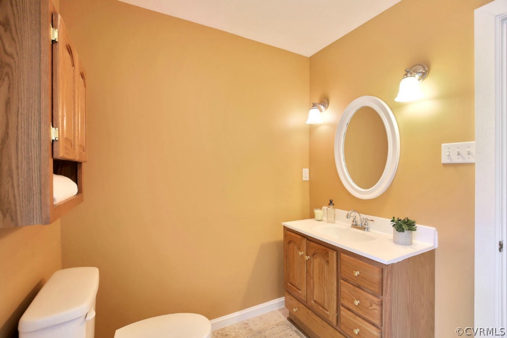 14060 Beach Road Chesterfield, VA 23838 - Photo 18 of 24 a bathroom with a sink mirror vanity and toilet