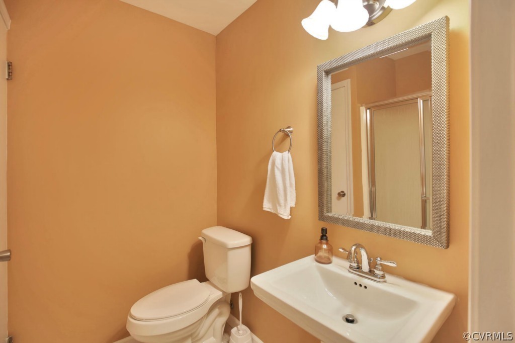 14060 Beach Road Chesterfield, VA 23838 - Photo 10 of 24 a bathroom with a sink a toilet and mirror
