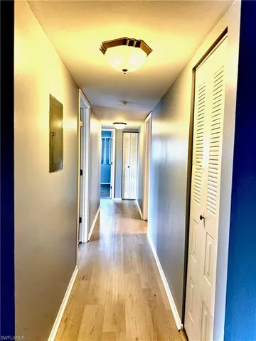 a view of hallway with wooden floor
