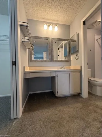 a view of cabinets and a room with wooden floor