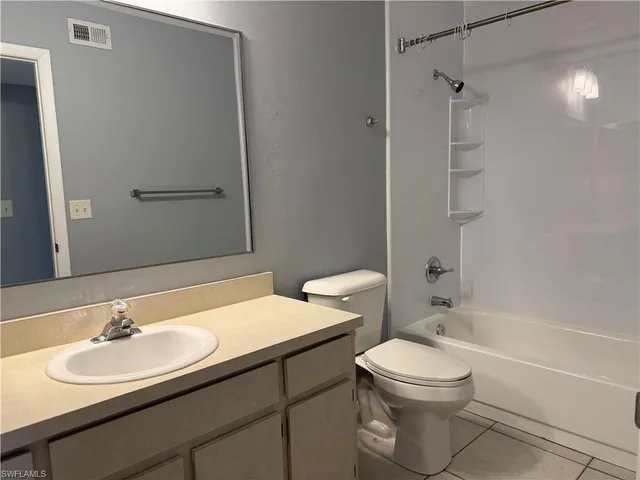a bathroom with a sink toilet a mirror and shower