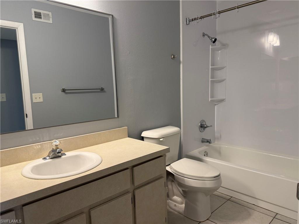6492 Royal Woods Drive, Unit 5 Fort Myers, FL 33908 - Photo 20 of 28 a bathroom with a sink toilet a mirror and shower