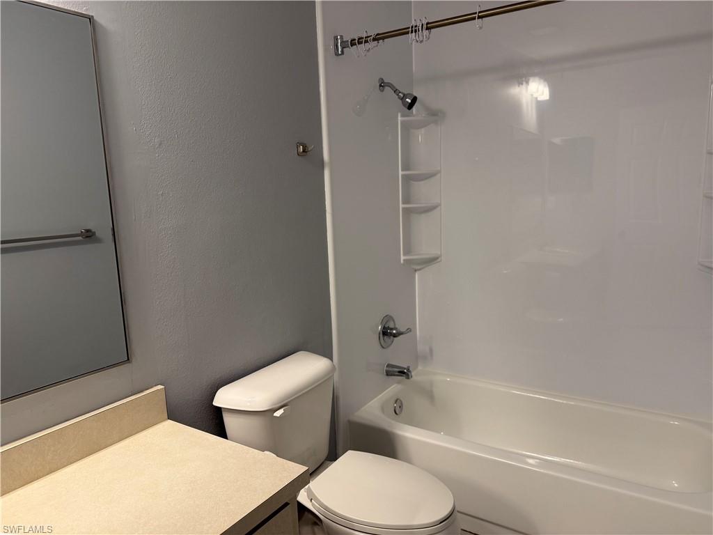 6492 Royal Woods Drive, Unit 5 Fort Myers, FL 33908 - Photo 21 of 28 a white toilet sitting next to a bath tub and a shower