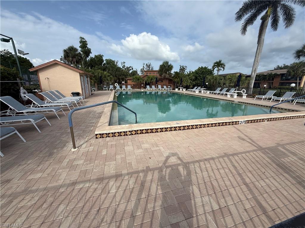 6492 Royal Woods Drive, Unit 5 Fort Myers, FL 33908 - Photo 24 of 28 a view of swimming pool with seating space and lake view