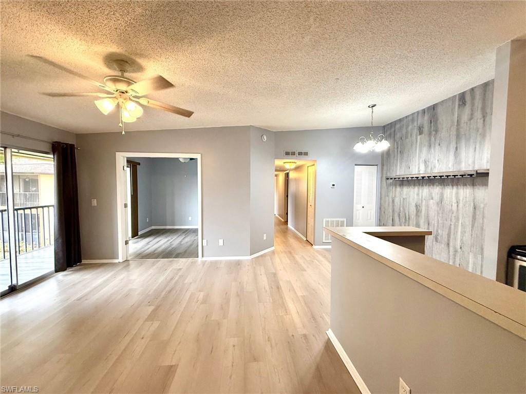 6492 Royal Woods Drive, Unit 5 Fort Myers, FL 33908 - Photo 3 of 28 a view of an empty room with window and wooden floor