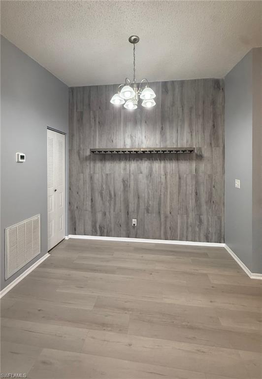 6492 Royal Woods Drive, Unit 5 Fort Myers, FL 33908 - Photo 5 of 28 a view of an empty room with wooden floor