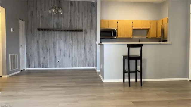 a view of a kitchen with a sink and a window