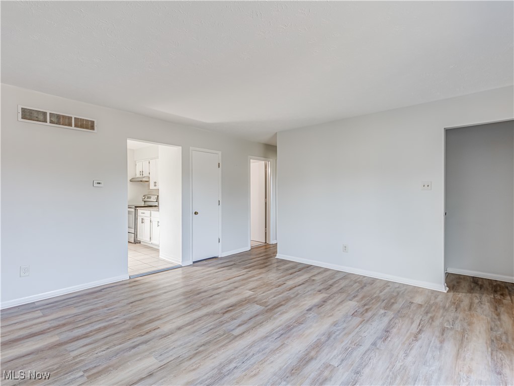 1456 Trares Road Mogadore, OH 44260 - Photo 7 of 20 Empty room with light hardwood / wood-style floors