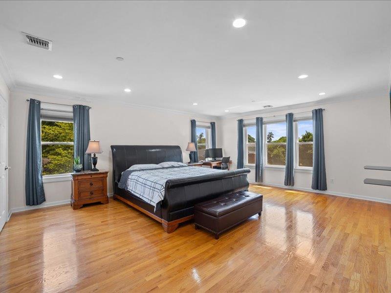 283 Harrison Avenue Harrison, NY 10528 - Photo 11 of 27 a spacious bedroom with a bed and a large window