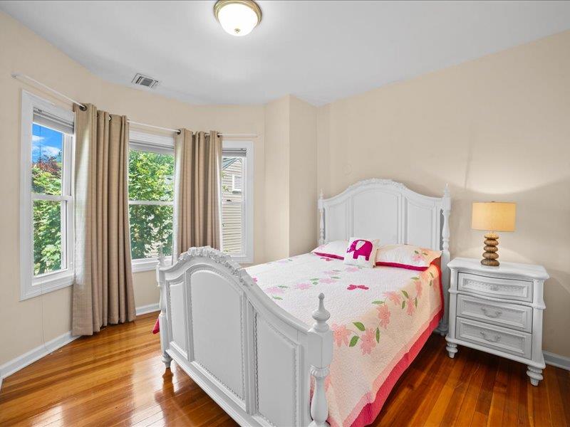 283 Harrison Avenue Harrison, NY 10528 - Photo 12 of 27 a bedroom with a bed a dresser and window