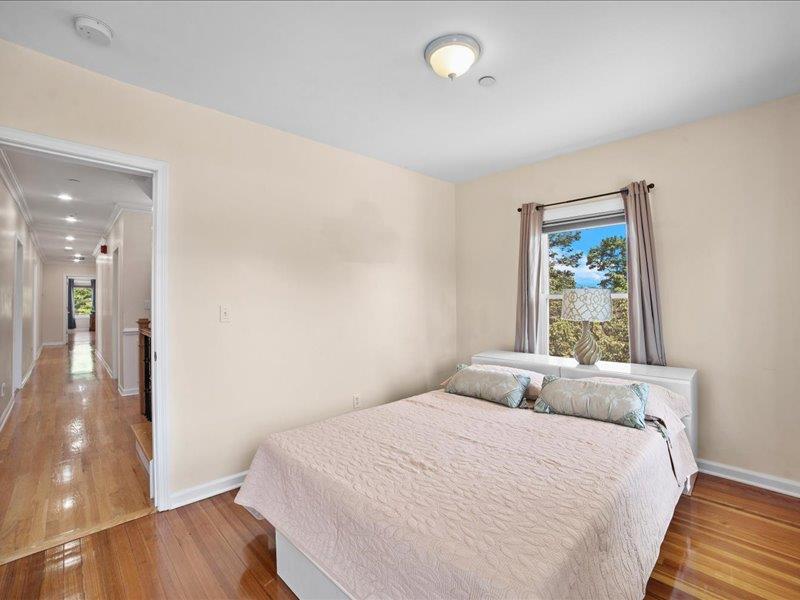 283 Harrison Avenue Harrison, NY 10528 - Photo 14 of 27 a bedroom with a large bed and a wooden floor