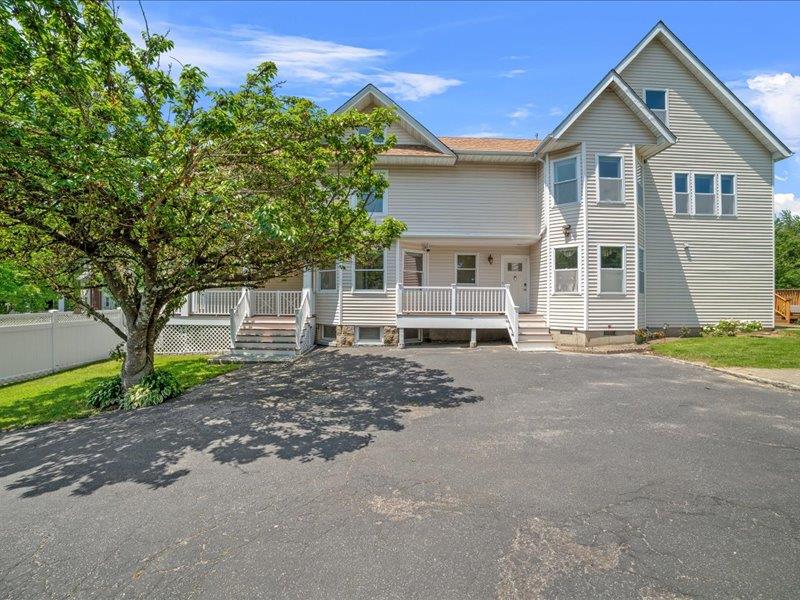 283 Harrison Avenue Harrison, NY 10528 - Photo 22 of 27 a front view of a house with a yard and a garage