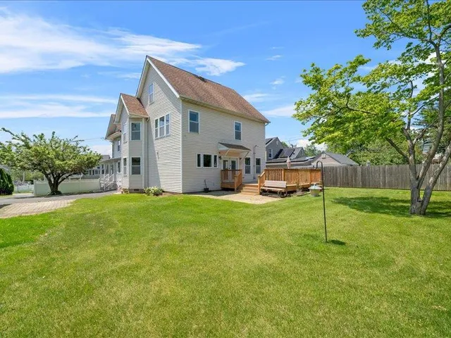 a view of a back yard with a bench