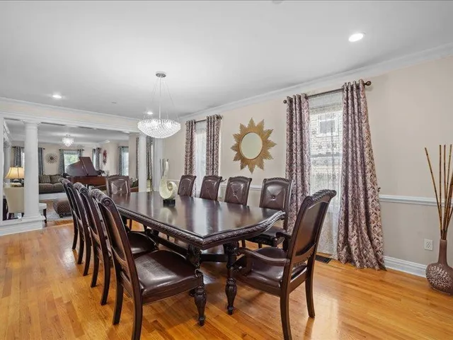 a dining room with furniture and wooden floor