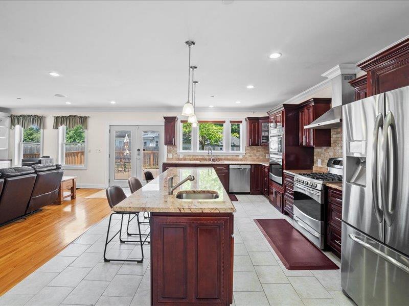 283 Harrison Avenue Harrison, NY 10528 - Photo 27 of 27 a kitchen with stainless steel appliances granite countertop a refrigerator and a stove top oven