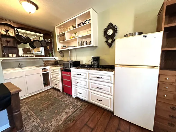 a kitchen with a refrigerator and cabinets