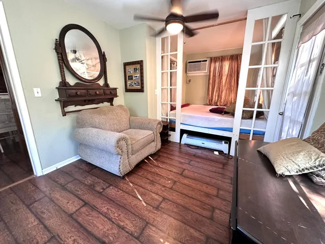 a living room with furniture a rug and a window