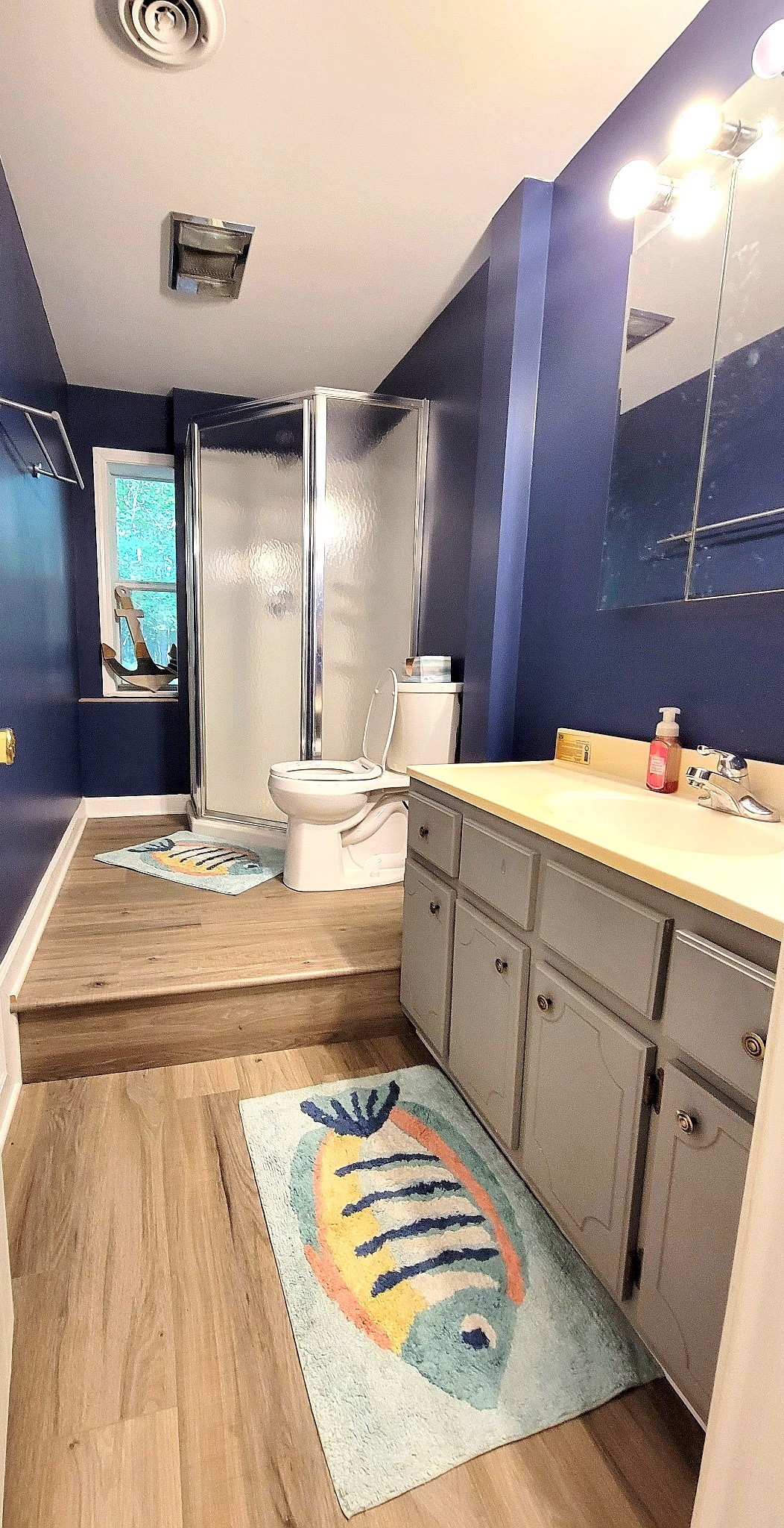 1377 4 Seasons Road Smithville, TN 37166 - Photo 10 of 16 a room with a mirror and a sink