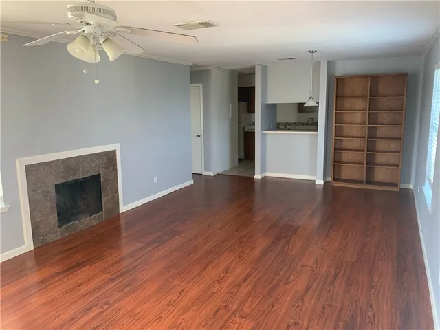 a view of a kitchen with wooden floor and a ceiling fan