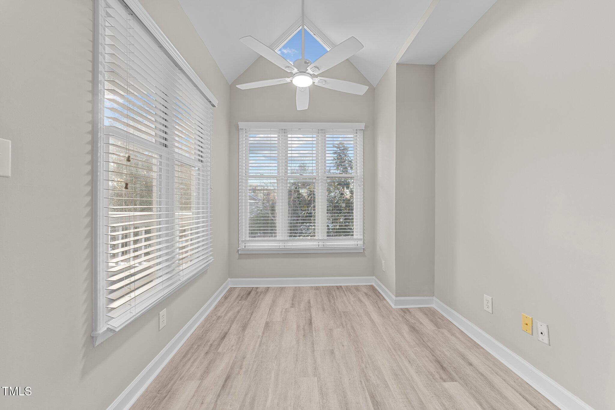 243 New Bern Place, Unit 301 Raleigh, NC 27601 - Photo 12 of 31 a view of an empty room with wooden floor and a window