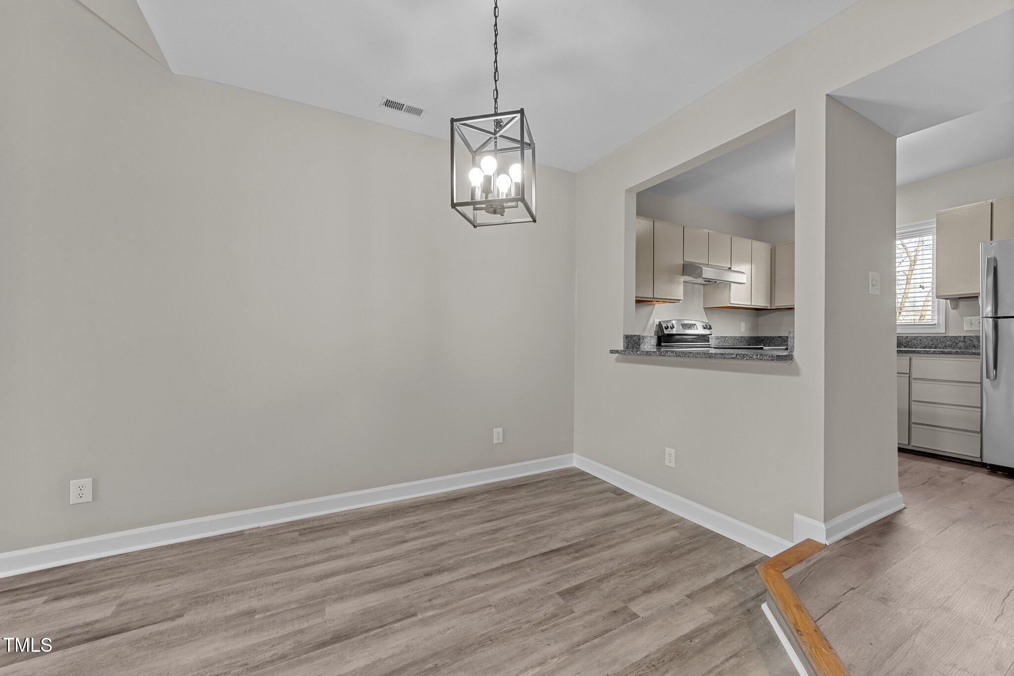243 New Bern Place, Unit 301 Raleigh, NC 27601 - Photo 5 of 31 a view of a room with wooden floor