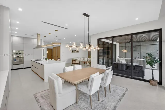 a large kitchen with a table and chairs