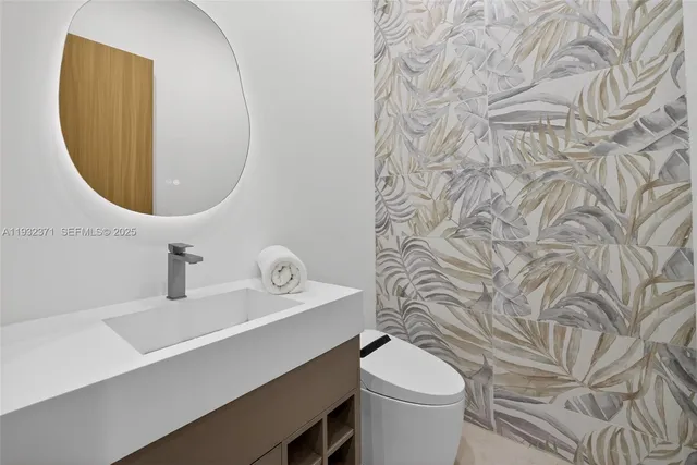 a bathroom with a sink a toilet and a mirror