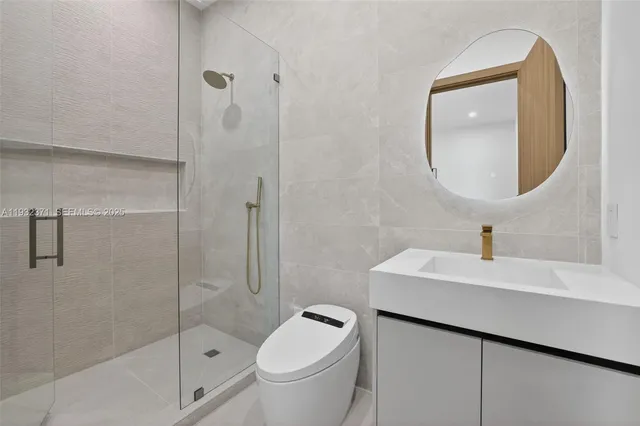 a bathroom with a sink toilet and shower