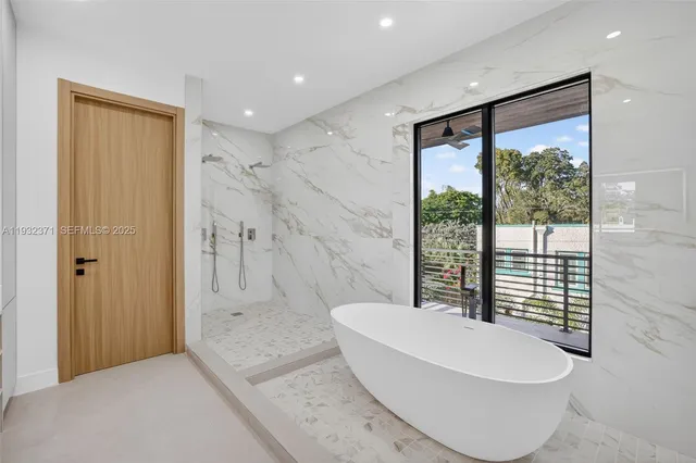 a bathroom with a bathtub and shower