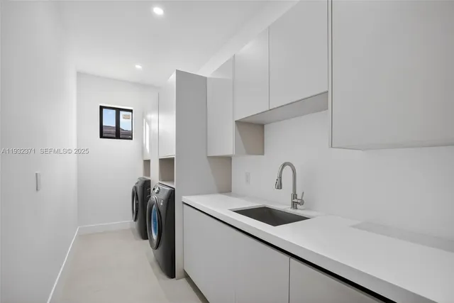 a kitchen with a sink a refrigerator and cabinets