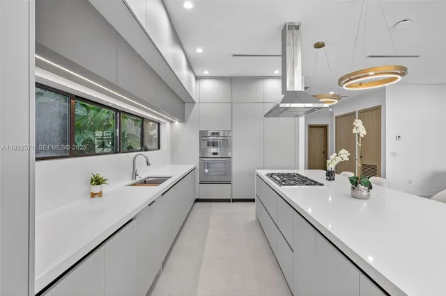 a large white kitchen with a large window