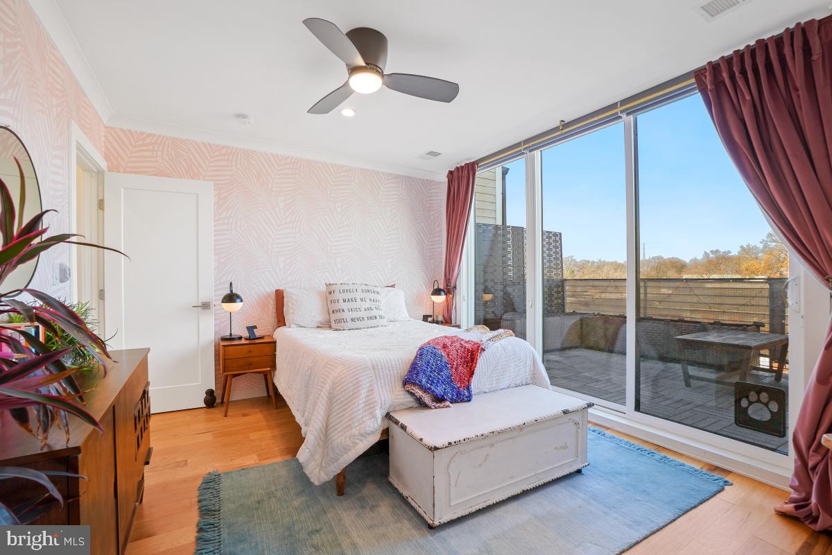 111 Varnum Street Northwest, Unit 3 Washington, DC 20011 - Photo 16 of 21 a spacious bedroom with a large bed and a chandelier