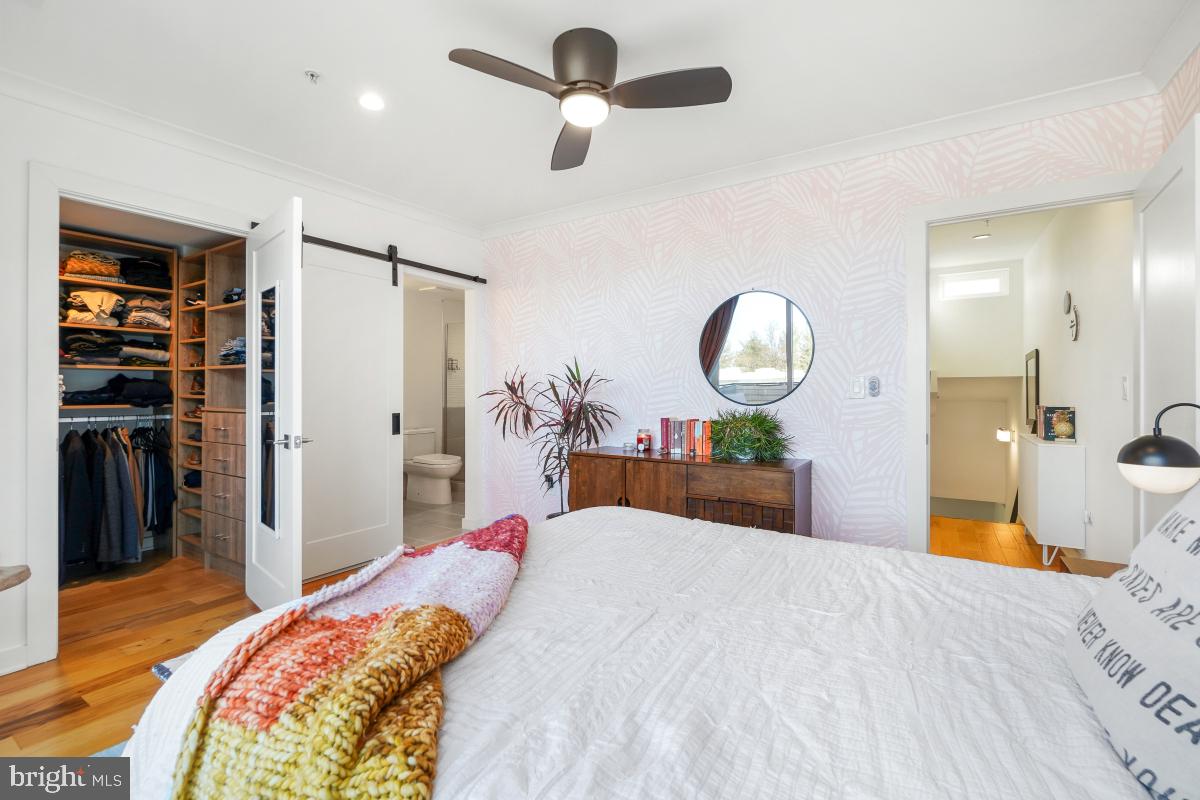 111 Varnum Street Northwest, Unit 3 Washington, DC 20011 - Photo 17 of 21 a bedroom with a bed and a chandelier