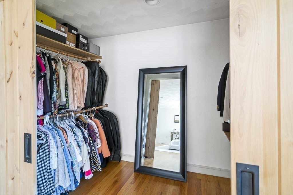 28 Longmeadow Road Arlington, MA 02474 - Photo 15 of 25 a view of walk in closet with clothes and shoes
