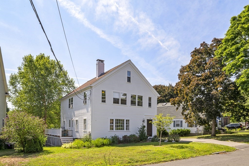 28 Longmeadow Road Arlington, MA 02474 - Photo 23 of 25 a view of a white house with a big yard and large trees