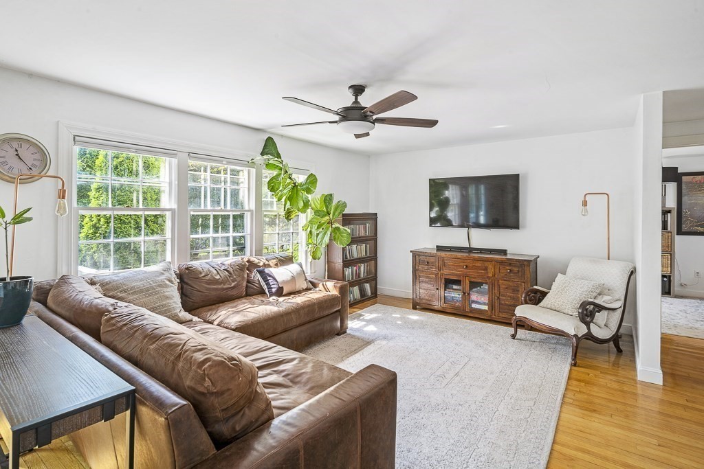 28 Longmeadow Road Arlington, MA 02474 - Photo 6 of 25 a living room with furniture a fireplace and a flat screen tv